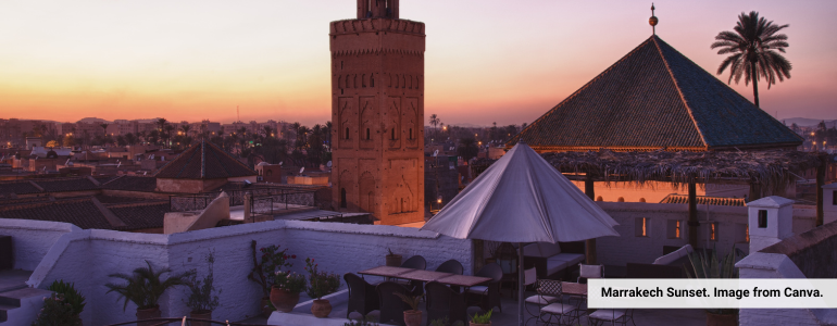 Marrakech at sunset on the rooftop of a Moroccan Riad, overlooking The Red City.