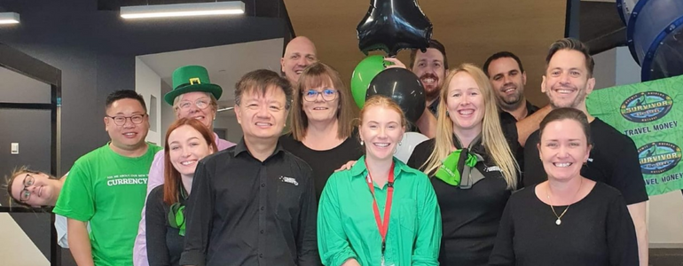 Travel Money Oz head office team photo (all genders), taken on our one-year anniversary since reopening our doors!