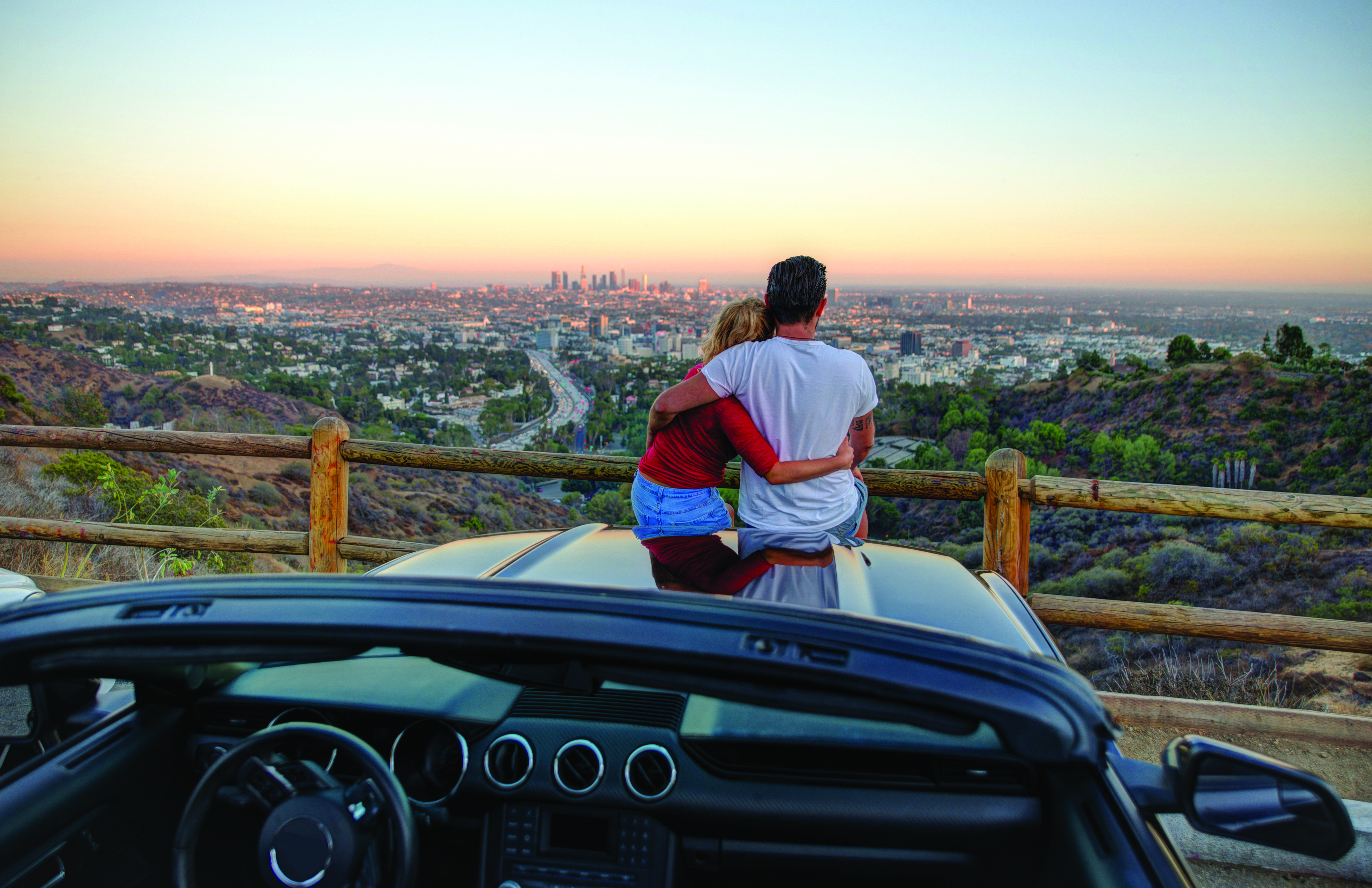 Couple overlooking Los Angeles at sunset